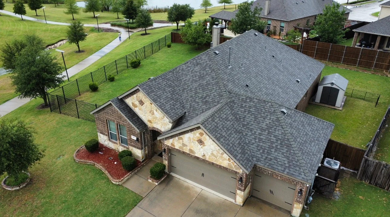 Aerial view of brick home with new charcoal gray architectural shingle roof